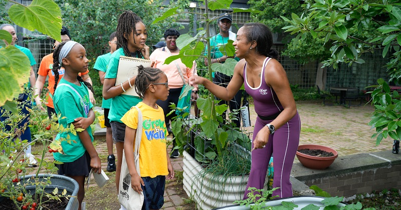 Alumna Latiaynna King (right) teaches children about plants during one of Black Girls with Green Thumbs’ educational programs. 