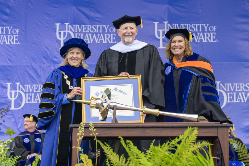 UD President Laura Carlson (left) and Board Chair Terri L. Kelly (right) awarded an honorary doctor of humane letters degree to Joseph August Pika III, UD professor emeritus.
