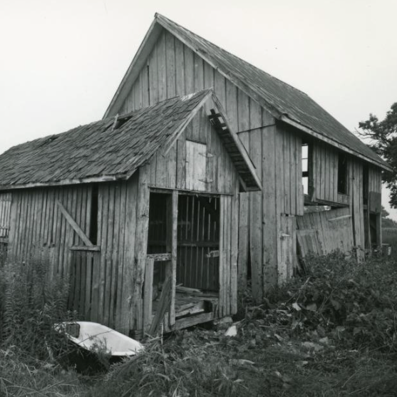 Black and white exterior photo of a threatened New Castle County property