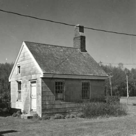 Black and white exterior photo of a threatened Sussex County property