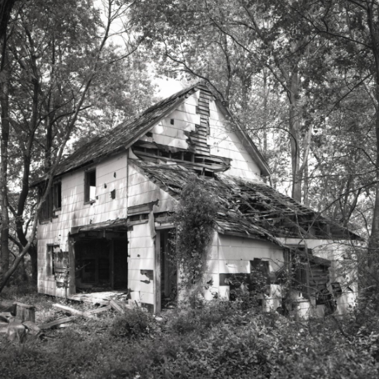 Black and white exterior photo of a portion of the Ross Mansion