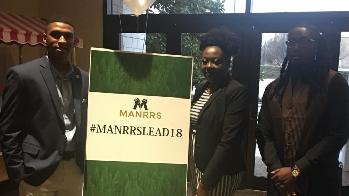 Three black graduate students pose with the entrance sign of the MANRRS 2018 National Conference.