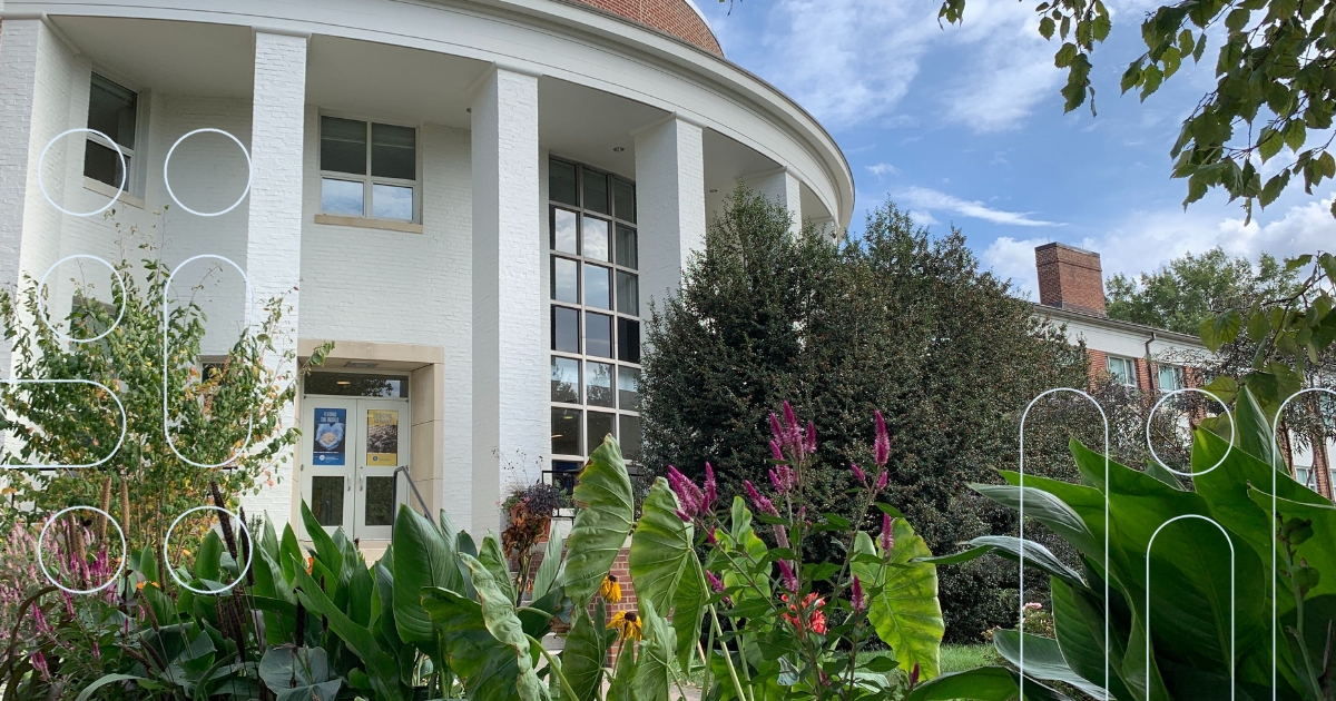 The outside of Townsend Hall with floers blooming in the front gardens.