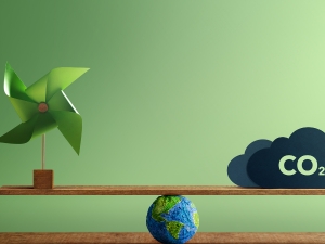 co2 and a windmill on a teeter tooter above the earth