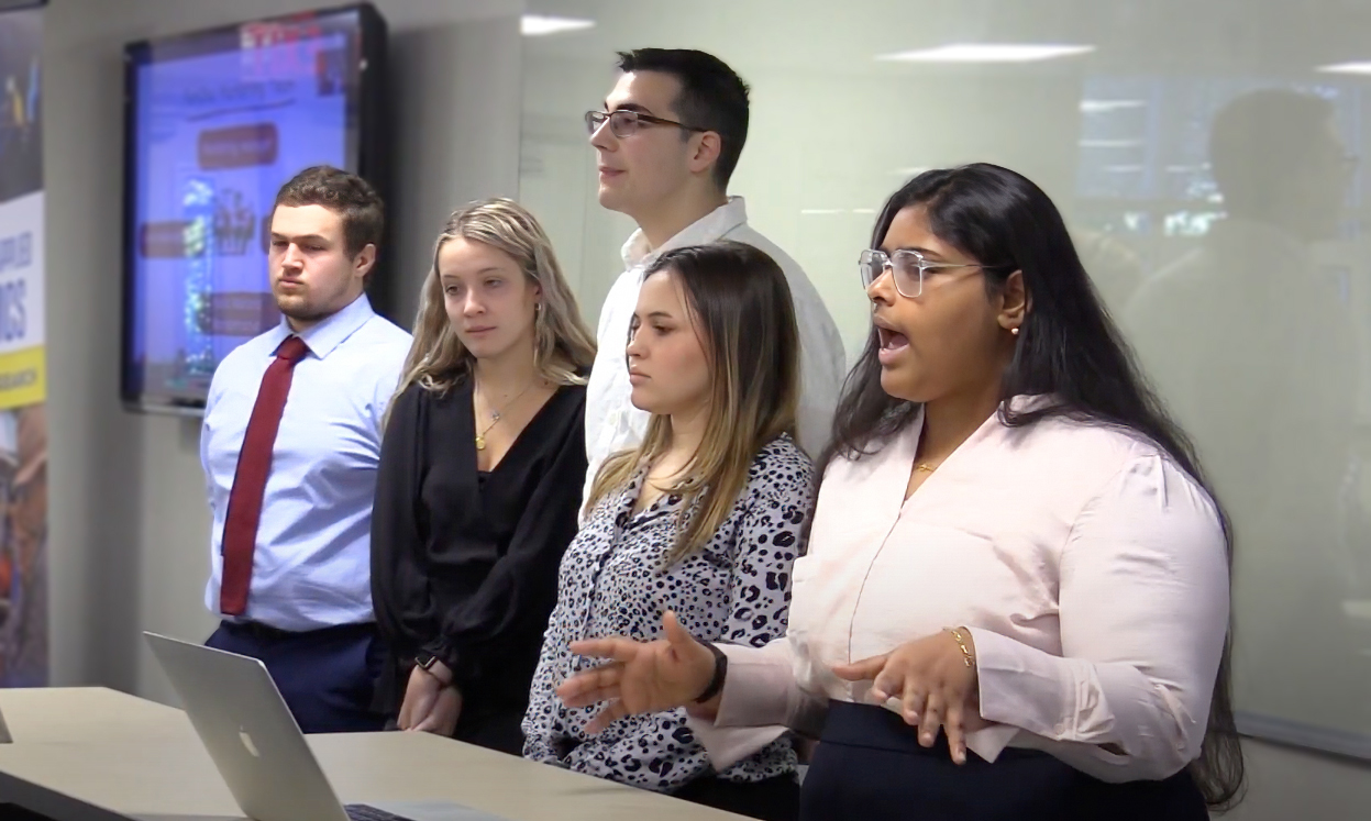 Five NAMA club members practice their public speaking.