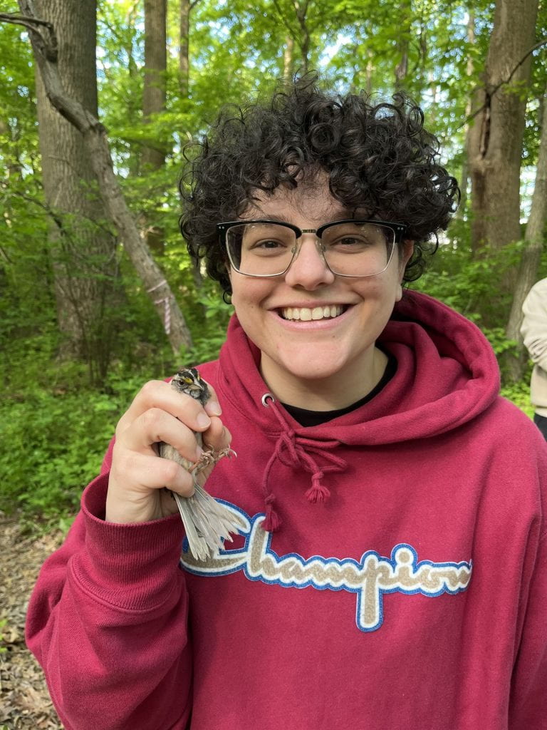 Emily holding  a bird.