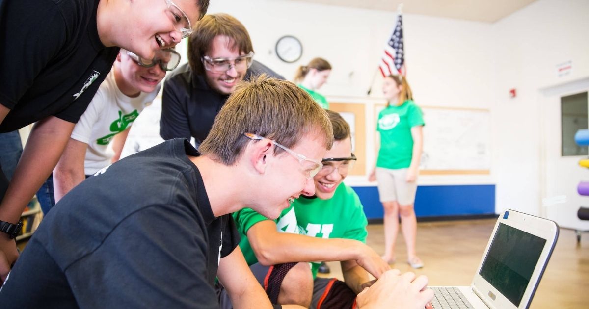 4-Hers work together on a computer challenge
