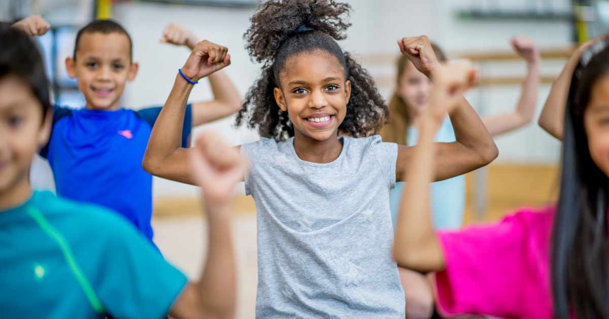 Children showing their arm muscles in an exercise class.
