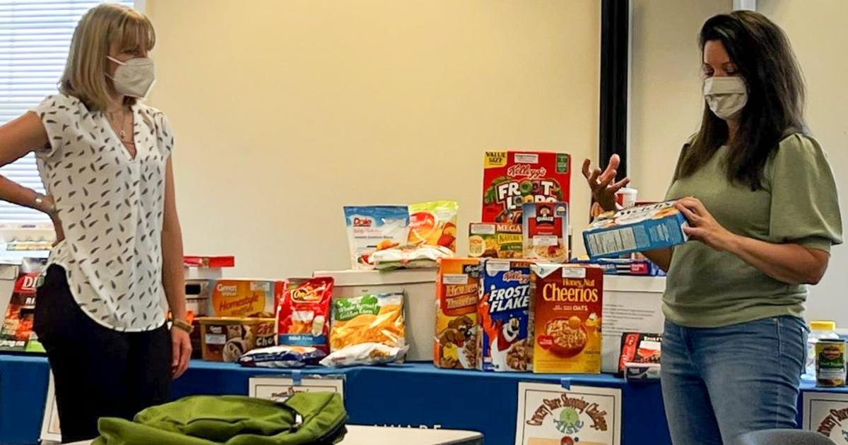 Master Wellness volunteers present about nutrition in front of a group.