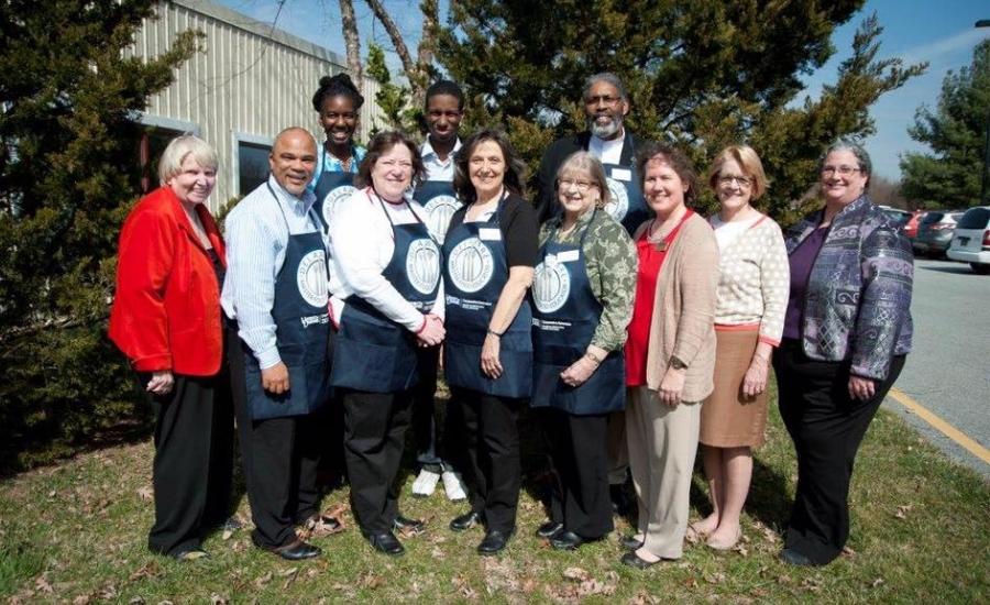 Eleven Master Food Educator volunteers and teachers pose for a class photo.