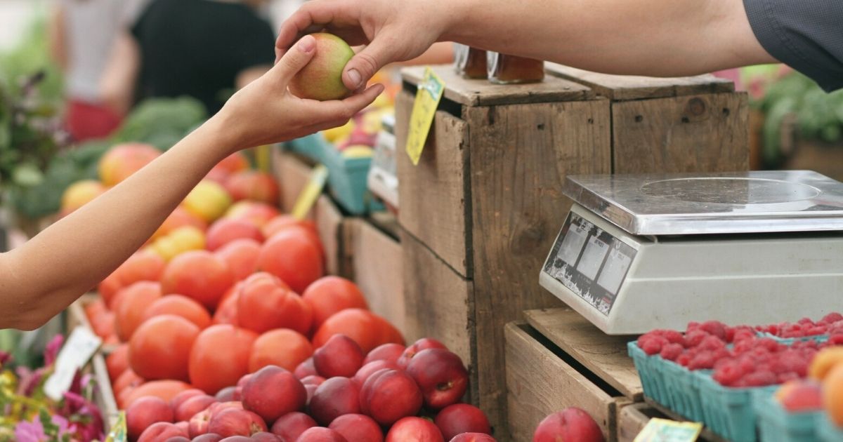 A person shopping at a farmer's market A person shopping at a farmer's market