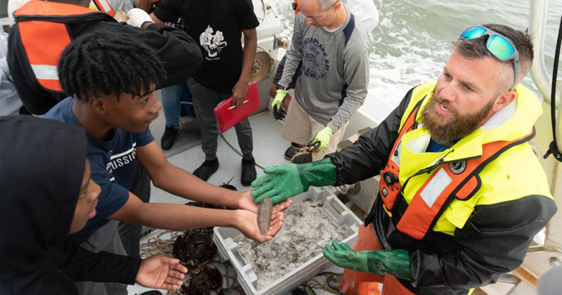 Ed Hale instructing local students on aquaculture