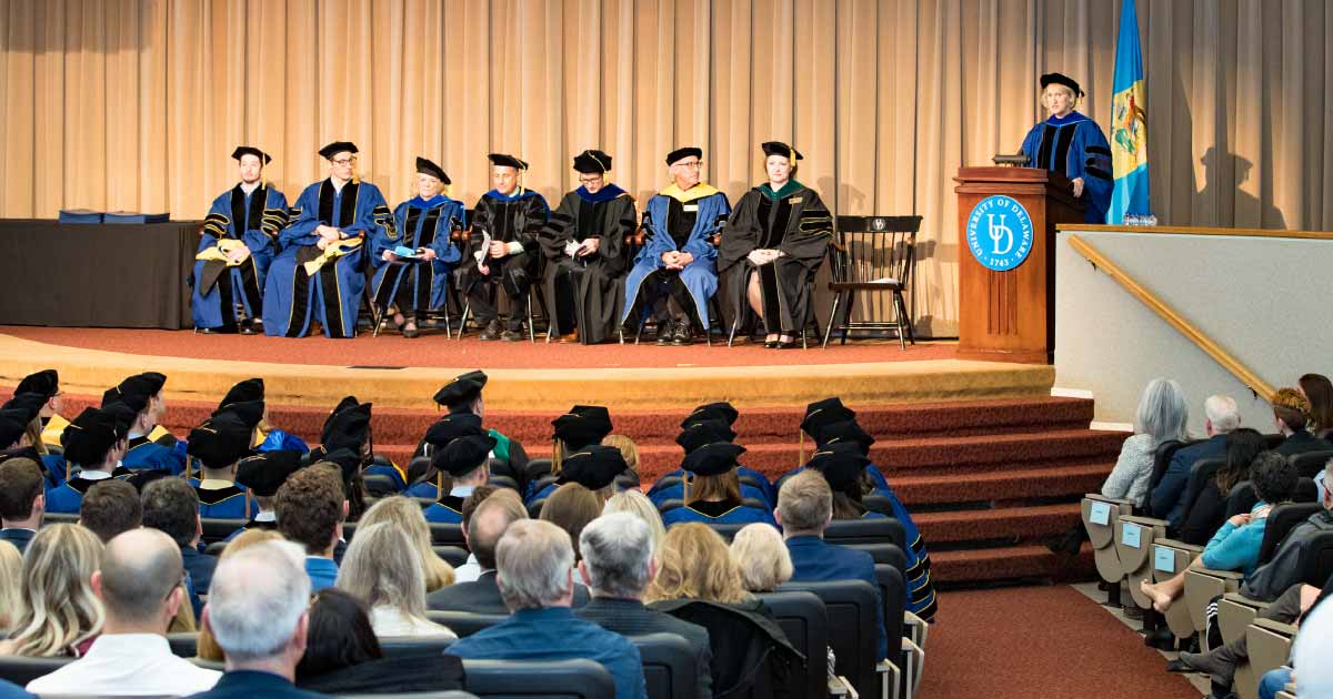 Graduation ceremony with students and professors in auditorium 