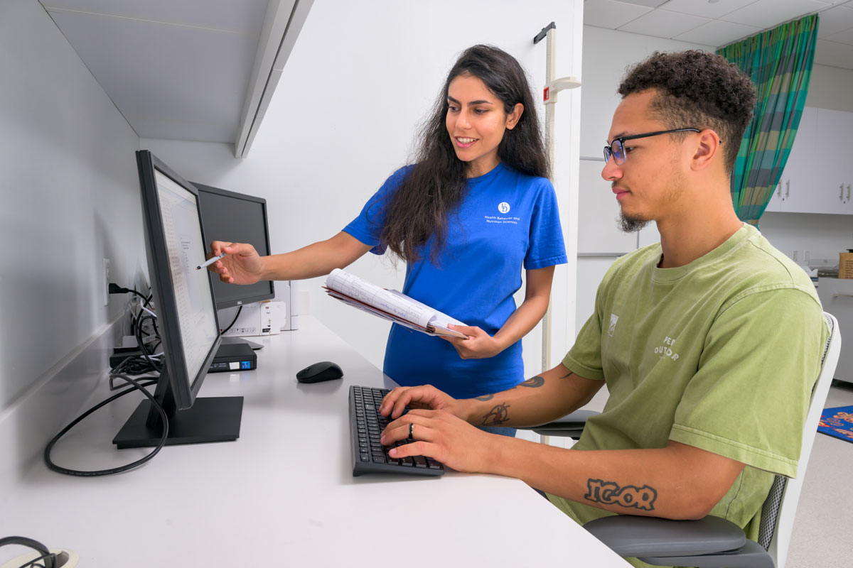 Human nutrition students looking at a computer screen