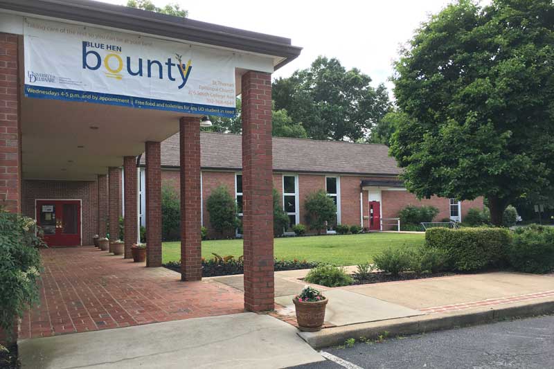 Exterior of St. Thomas' Parish with a Blue Hen Bounty sign