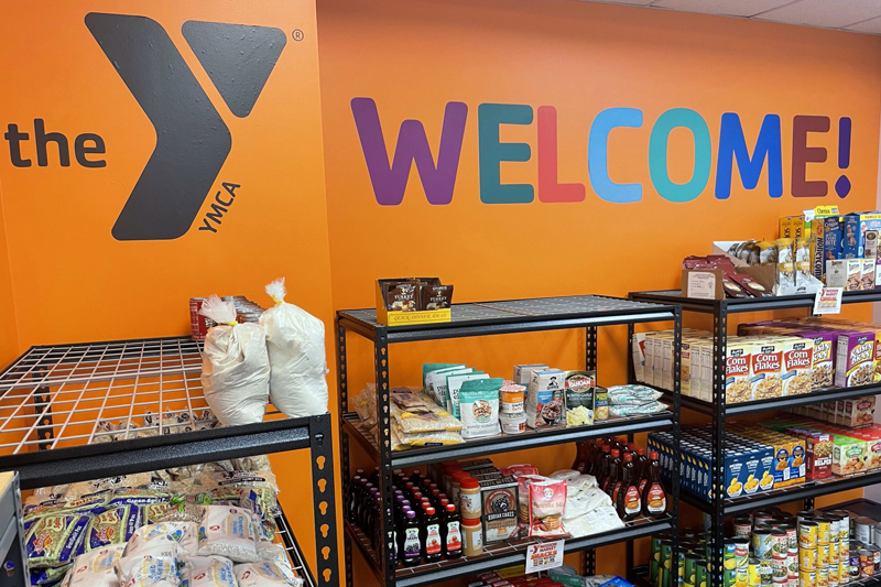 shelves of food line orange walls at the Y Mission Market