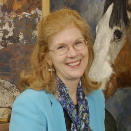 UD Prof. Joyce Hill-Stoner, art conservation, in her studio at Winterthur Museum. behind her is a Maxfield Parrish (L) and a Jaimie Wyeth (Rt)