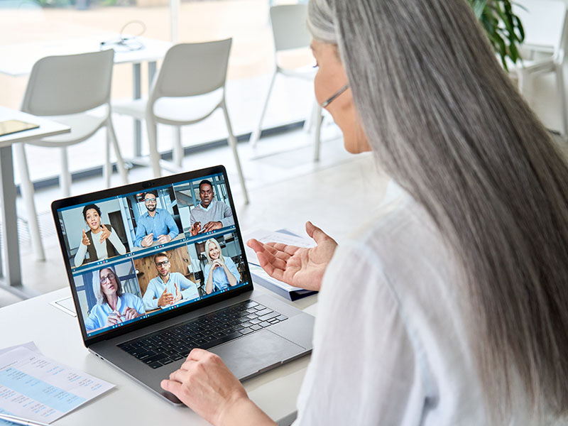 Woman participating in virtual meeting on laptop