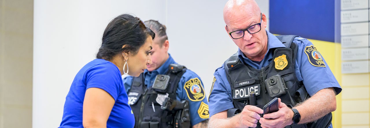 UDPD Officers chatting at an event.