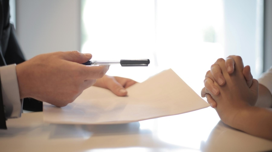 Photo of a person at a bank speaking with a banker.