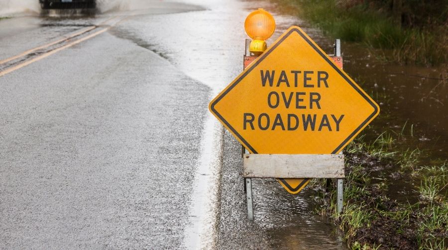A flooded road that says Water On Roadway.