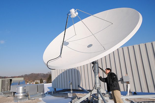 Satellite receiving station equipment installation on the roof of Willard Hall