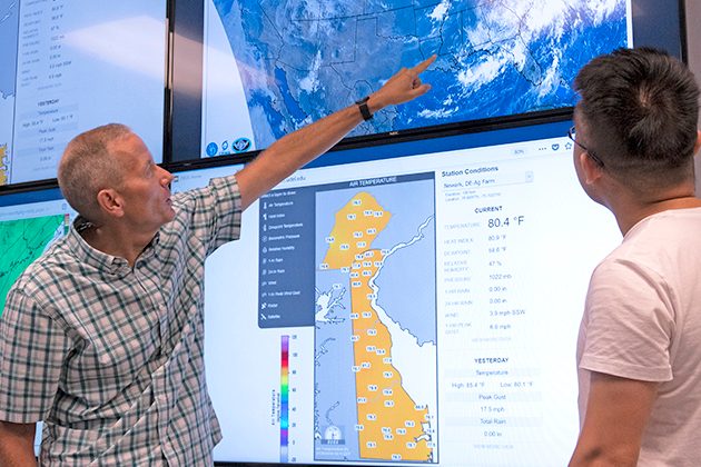 Student and professor in the Meteorology Visualization Lab