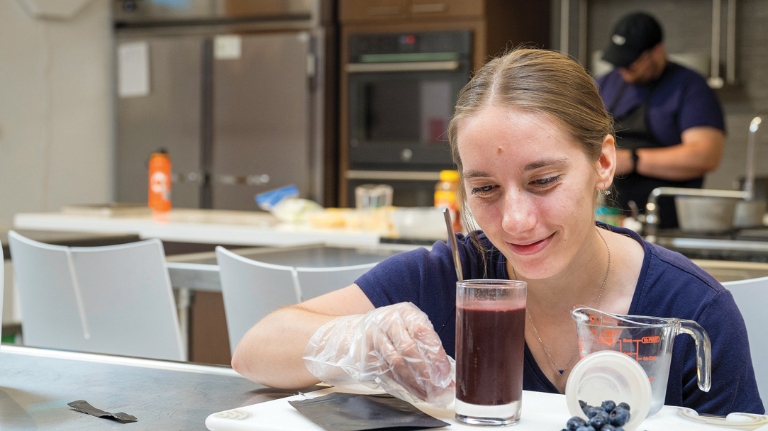 Students conducting science experiments on blueberries in the lab.