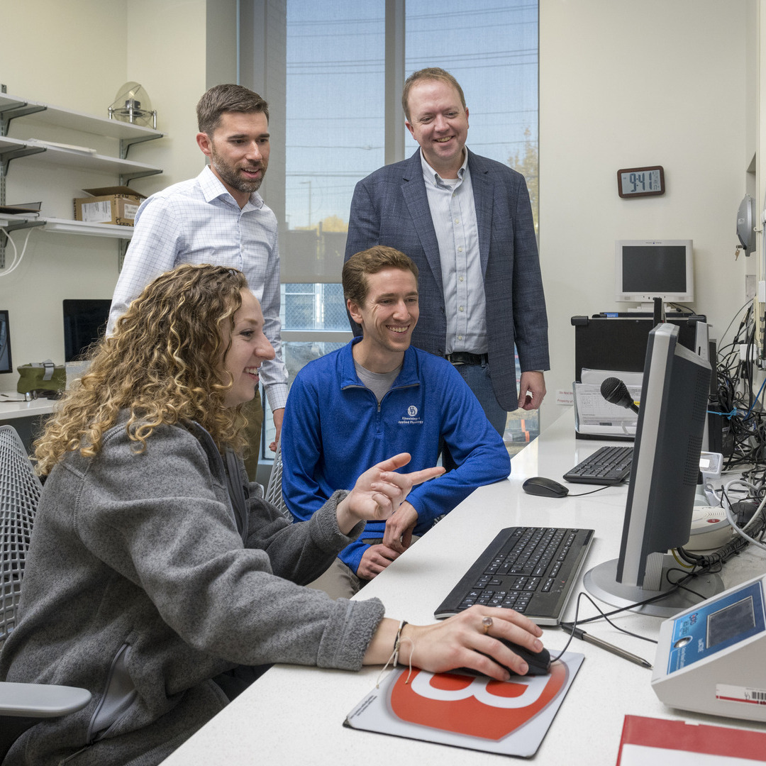 Kinesiology and Applied Physiology (KAAP) Associate Professor and DECCAR Director Chris Martens (white checked shirt/tan pants) and Associate Professor of Biomedical Engineering Curtis Johnson, an executive committee member with DECCAR (charcoal jacket/jeans) along with help from doctoral students Nate Romberger (CHS) and Mary Kramer (gray fleece sweater)