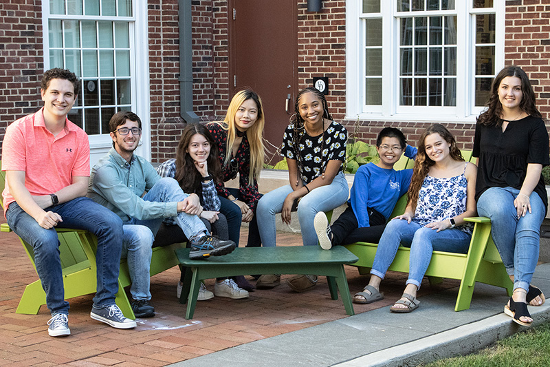 A group of resident assistants grouped together outside South Academy. 