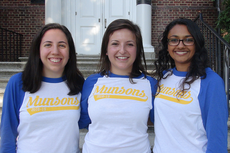 Three female Munson fellow standing side by side in front of a residence hall.