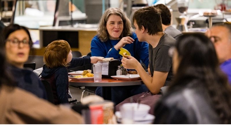 Student enjoys brunch with his family