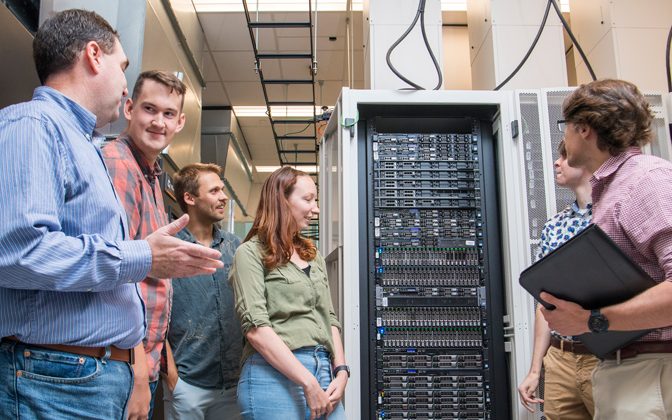 Program director Shawn Polson (left) describes the Biomix computational cluster while giving a tour of the data center at the Ammon Pinizzotto Biopharmaceutical Innovation Center to, from left to right, Jonathan Hicks, Joel Turk, Rachel Keown, Patrick Dopler and Anthony Shepherd.