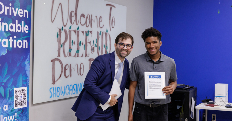 Dr. Salguiero with REEF finalist Errik Onyekwere in front of the classroom