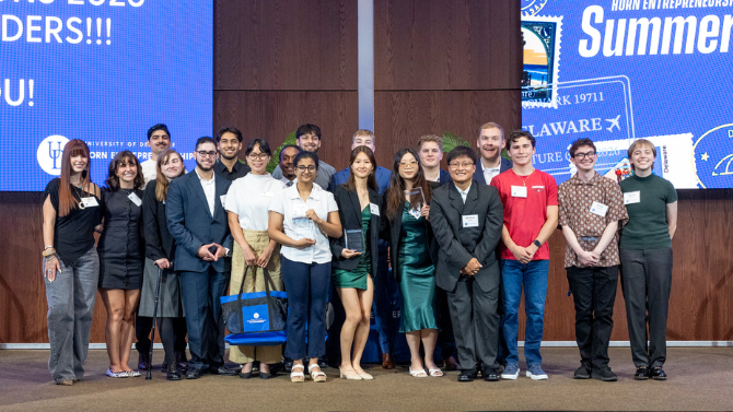 Photo of the summer founders students posed on stage
