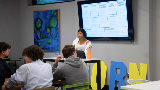 Emma McCabe discussing the business model canvas to students