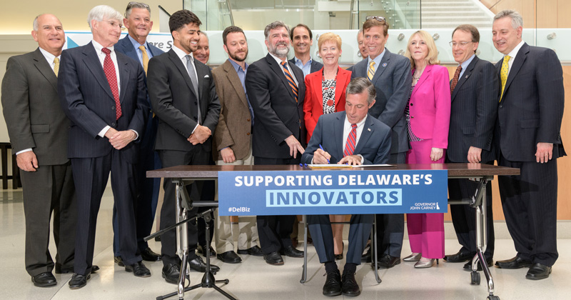 Delaware Governor John Carney joins UD President Dennis Assanis and other elected officials, entrepreneurs, and business representatives for a signing ceremony of "HB170: the Angel Investor Job Creation and Innovation Act for Small Technology Companies." The bill  "creates an incentive for qualified angel investors to invest capital in qualified Delaware small technology companies." [delaware.gov] - (Evan Krape / University of Delaware)