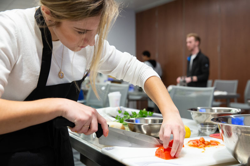 A cooking class with Jennifer Muzzi takes plan in the demo kitchen in the Tower at STAR during winter session.