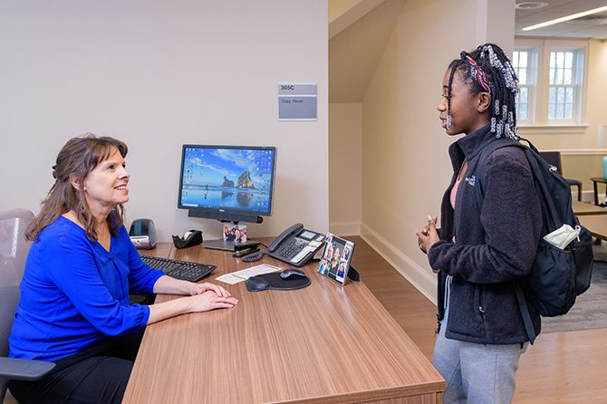 Student checks in at the front desk of Student Wellness and Health Promotion