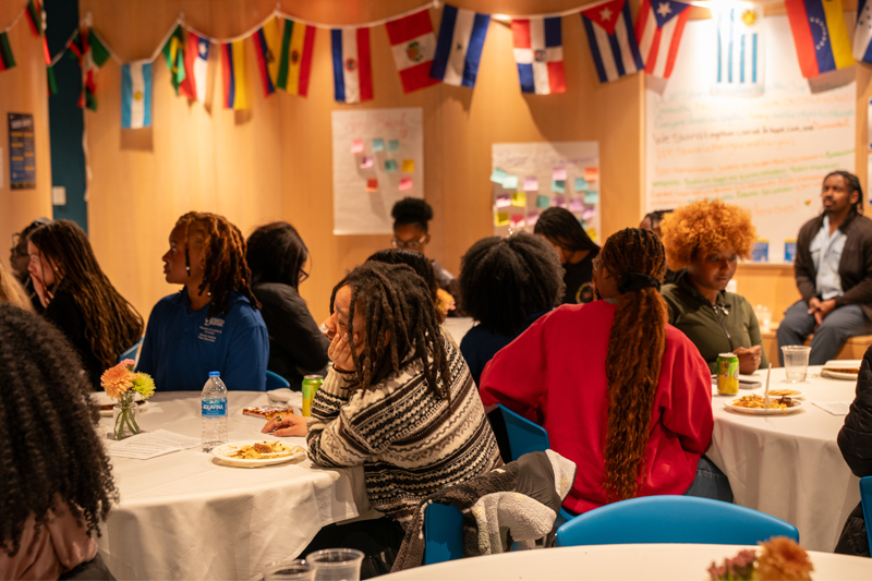 Students gather at tables for the Hot Takes Over Hot Plates event in the CEI.