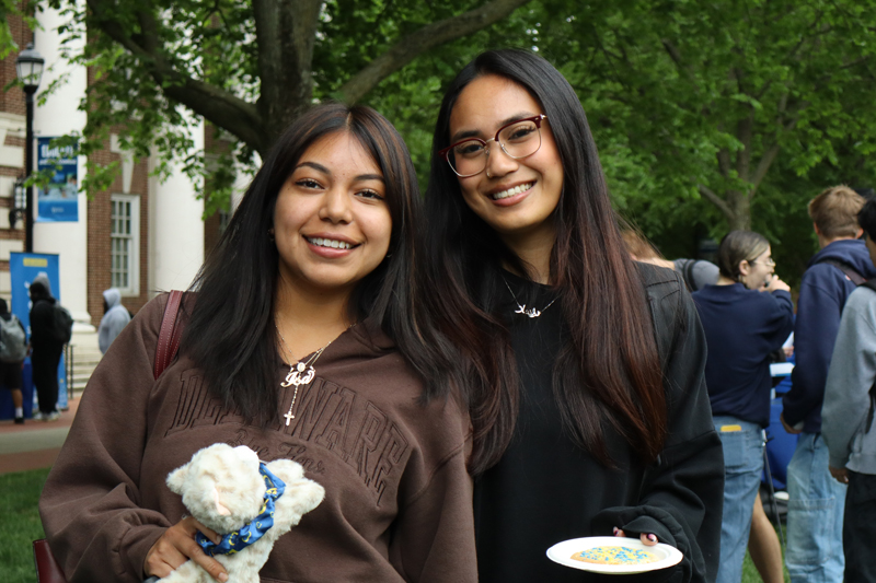 two smiling students pose on The Green