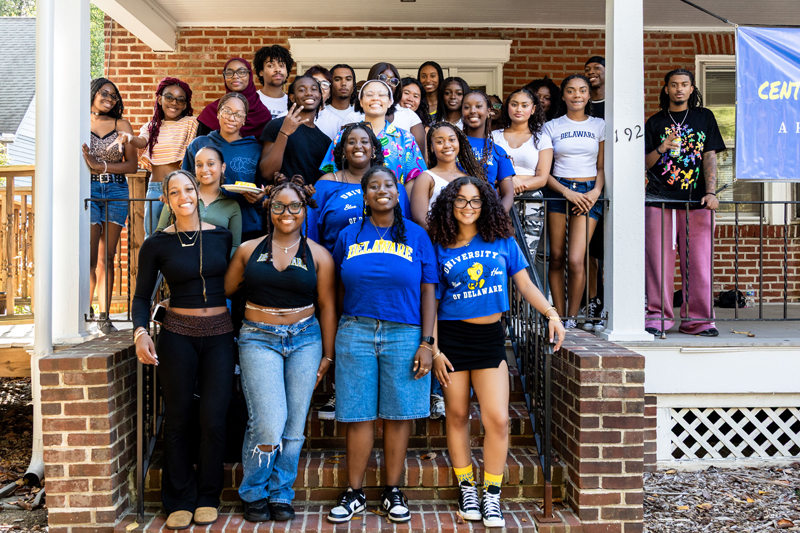 students in the Center for Black Culture  pose on the steps of the CBC building