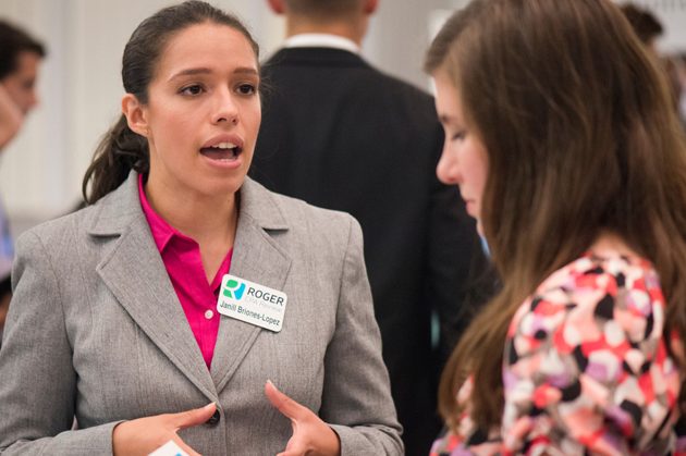an employer speaks with a student at a career fair