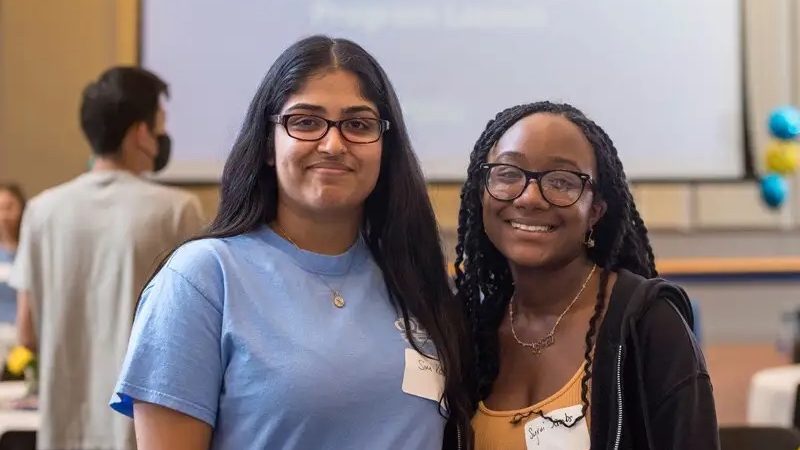 two students posing at an event