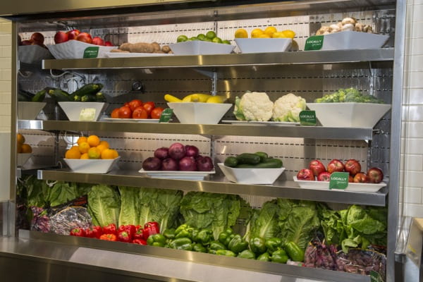Fresh fruits and vegetables arranged on shelves