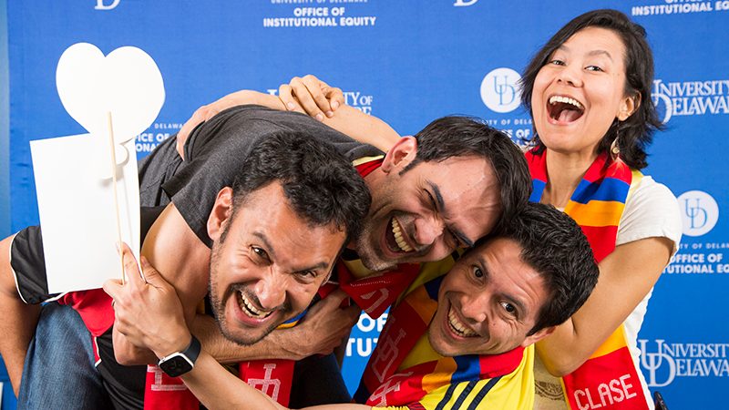 Students laugh and embrace at a Latinx stole ceremony