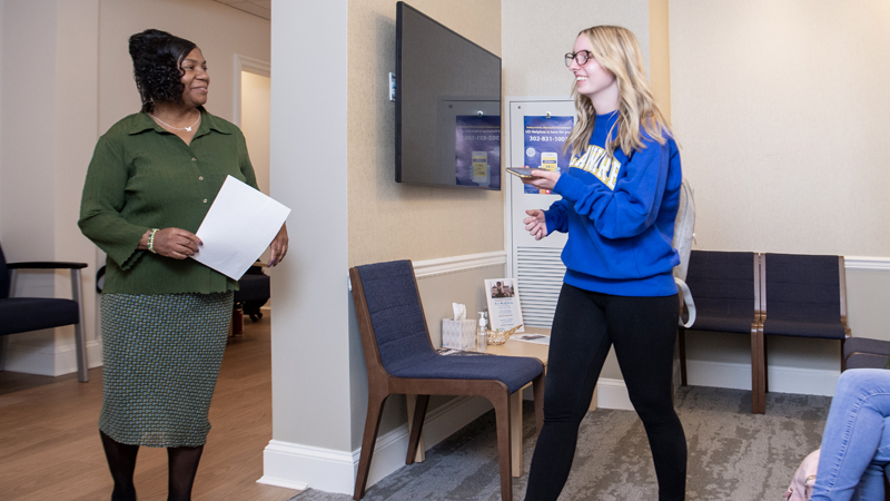 a student checks in for her appointment with a Wellbeing staff member