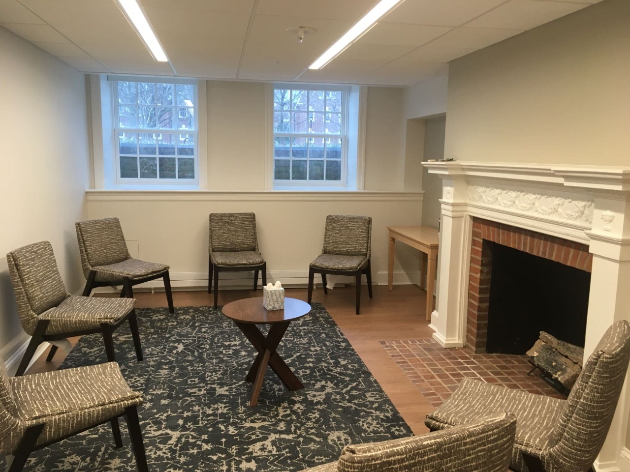 Small group discussion space with fireplace and chairs arranged in a circle