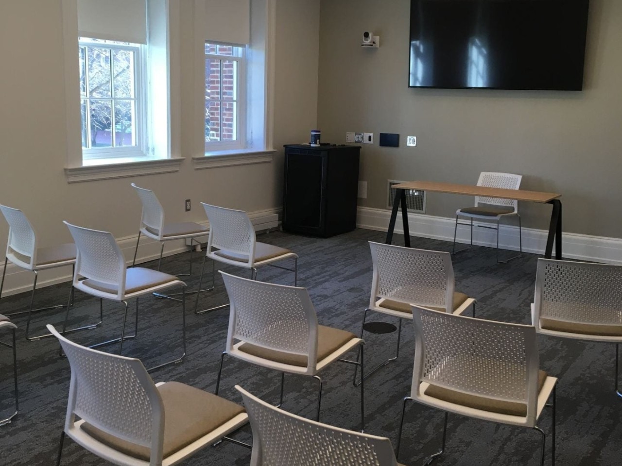 Warner Hall 107: room with chairs arranged in classroom style and a large digital display
