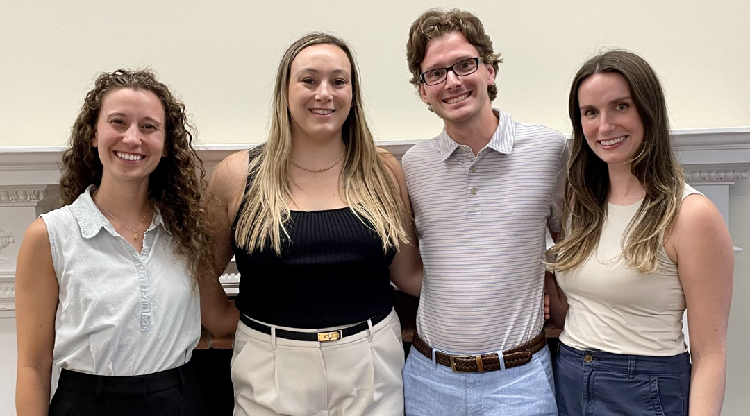 2024-25 Interns Internship cohort poses together in front of a white wall